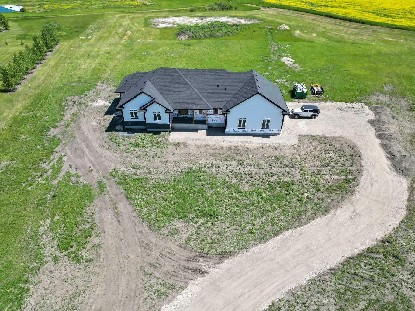 Property Photo: 349062 Tamarack Drive E AB T1S 5B8