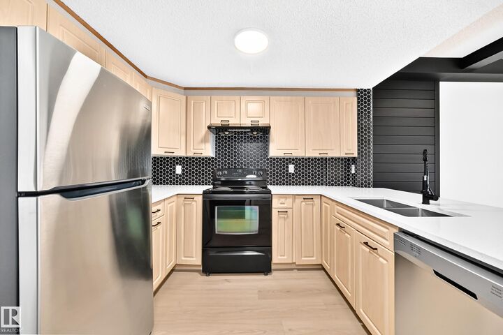 Property Photo:  6315 135 Avenue NW 323  AB T5A 5J7 