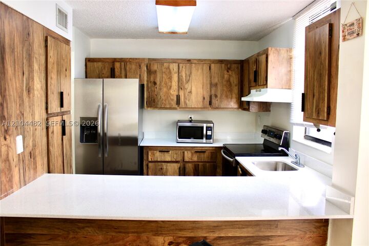 Property Photo:  18000 NW 68th Ave 409A  FL 33015 