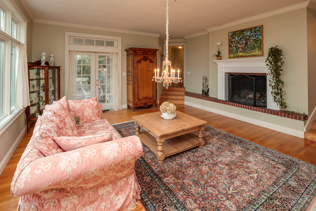 Property Photo: The living room is grand, and has two stairways leading to separate living spaces with a large gas fireplace with a large brick hearth between. the french doors lead out to the large covered patio of approximately 300 sf that overlook the incredible lands 819 14th St  WA 98225 